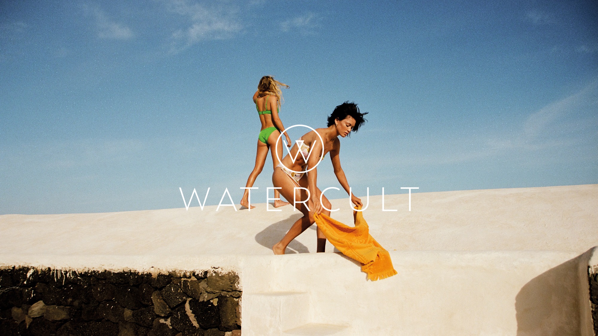 two models with watercult swimwear and the logo in the center